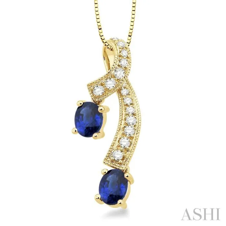 5x4MM Oval Cut Sapphire and 1/6 Ctw Round Cut Diamond Pendant in 14K Yellow Gold with Chain
